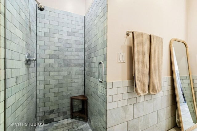 521 N Racine Ave Unit 3, Chicago, IL 60642 - full bath featuring a stall shower, a wainscoted wall, and tile walls