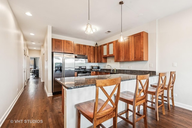521 N Racine Ave Unit 3, Chicago, IL 60642 - kitchen featuring stainless steel appliances, brown cabinets, dark wood-type flooring, a peninsula, and recessed lighting