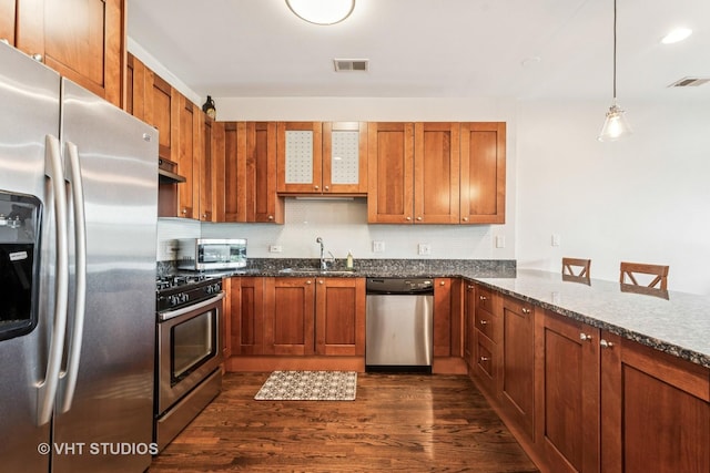 521 N Racine Ave Unit 3, Chicago, IL 60642 - kitchen with appliances with stainless steel finishes, a sink, dark wood-style flooring, backsplash, and dark stone countertops