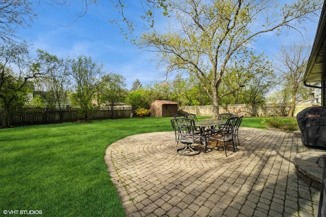 3935 Russett Ln, Northbrook, IL 60062 - view of yard featuring a fenced backyard, a storage unit, an outbuilding, and a patio area