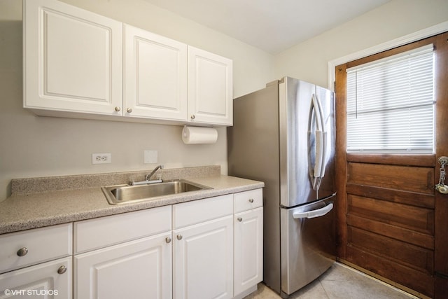 3935 Russett Ln, Northbrook, IL 60062 - kitchen with freestanding refrigerator, white cabinetry, a sink, and light countertops