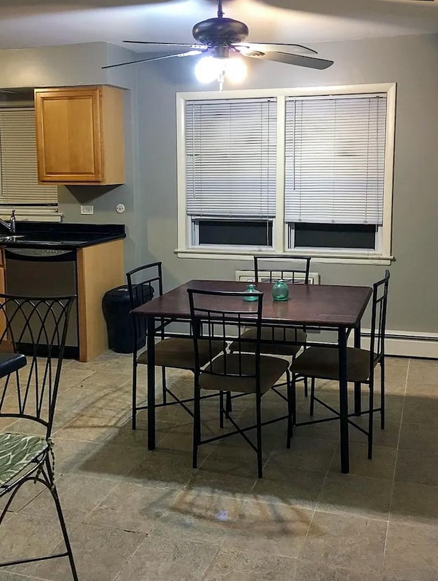 dining space with a ceiling fan and a baseboard radiator