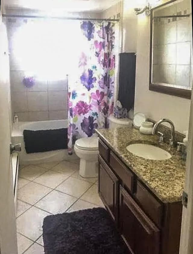 full bathroom with tile patterned floors, vanity, toilet, and shower / bath combination with curtain