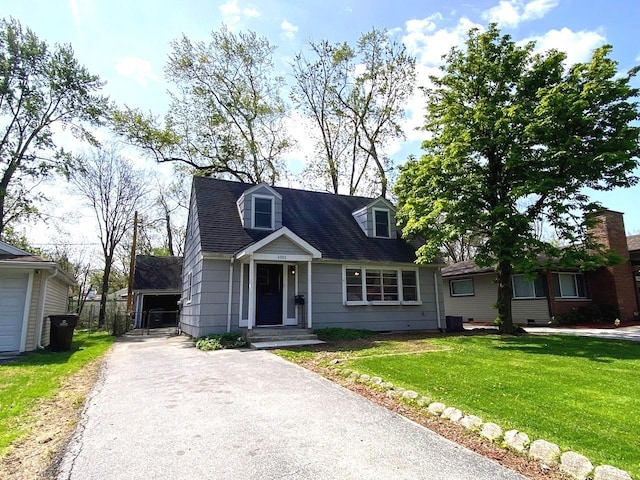 cape cod home with a front lawn and aphalt driveway