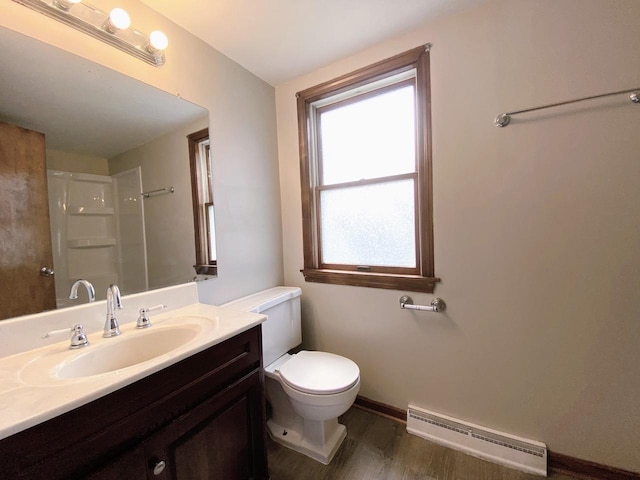 full bath featuring baseboard heating, vanity, toilet, wood finished floors, and a shower