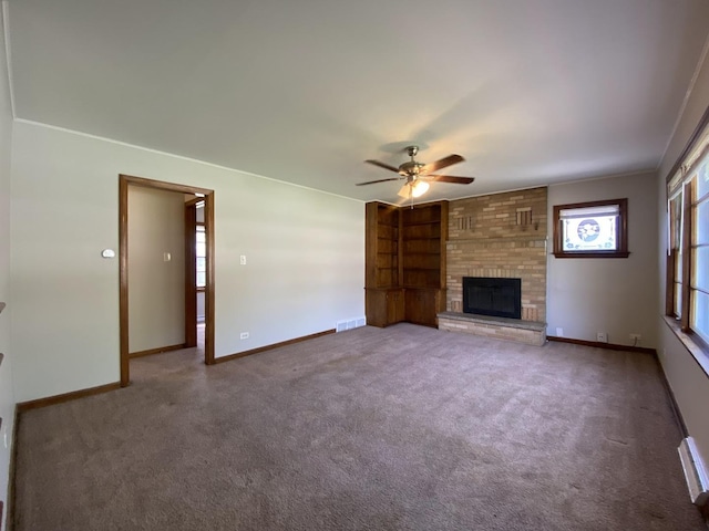 unfurnished living room with visible vents, a brick fireplace, baseboards, a ceiling fan, and carpet