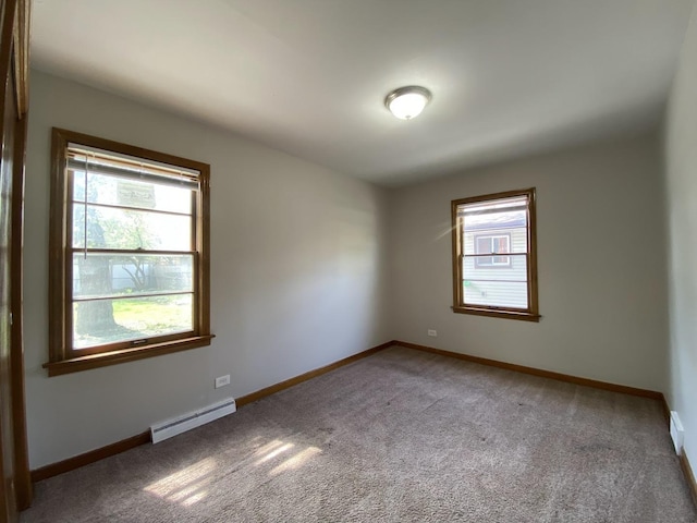 carpeted spare room with baseboards and baseboard heating
