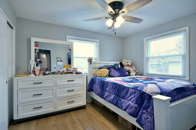 bedroom with a ceiling fan and light wood finished floors