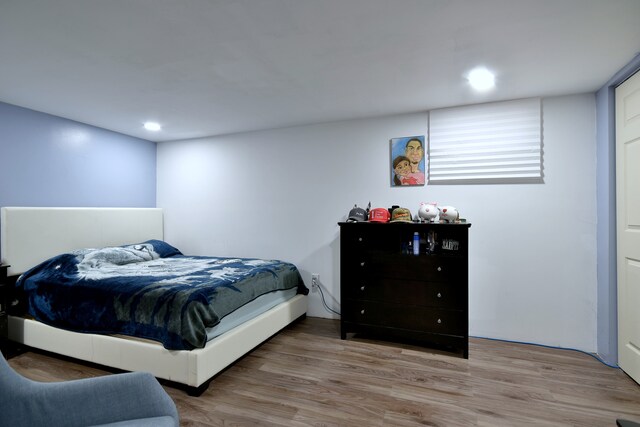 bedroom featuring recessed lighting and wood finished floors