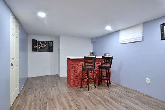 bar featuring light wood-style floors, a dry bar, and recessed lighting