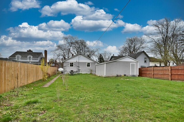 view of yard with a fenced backyard and an outdoor structure
