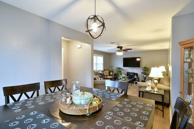 dining room featuring a ceiling fan and wood finished floors