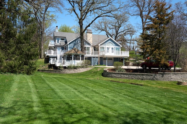 24270 N Forest Dr, Lake Zurich, IL 60047 - back of house featuring a balcony, a yard, and a chimney