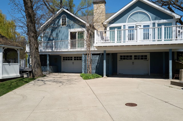 24270 N Forest Dr, Lake Zurich, IL 60047 - view of front of property with a garage, a chimney, a balcony, and driveway