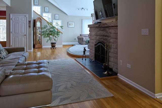 24270 N Forest Dr, Lake Zurich, IL 60047 - living room with plenty of natural light, wood finished floors, a fireplace, baseboards, and vaulted ceiling