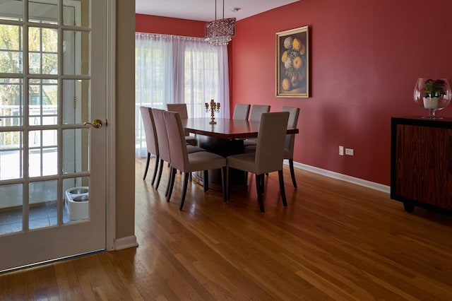 24270 N Forest Dr, Lake Zurich, IL 60047 - dining area featuring a chandelier, wood finished floors, and baseboards