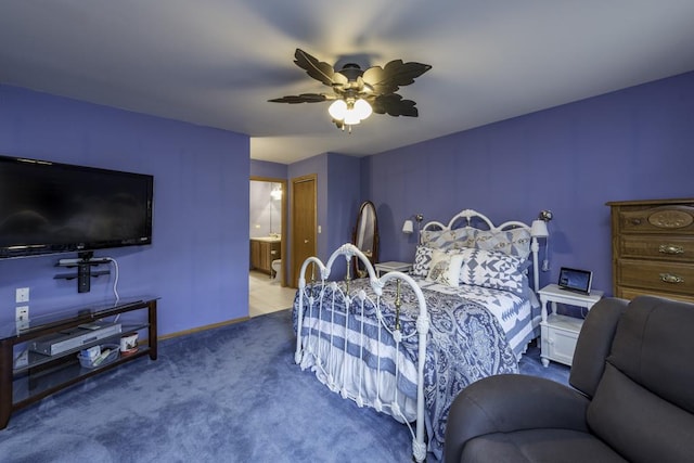 carpeted bedroom featuring baseboards, a ceiling fan, and ensuite bath