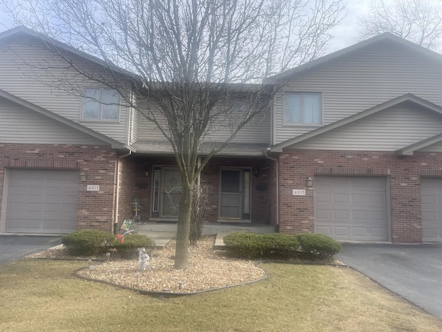 4305 W Termunde Dr, Alsip, IL 60803 - view of front of home with an attached garage, driveway, a front lawn, and brick siding