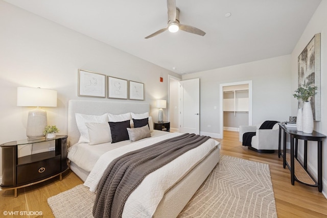 514 Hillgrove Ave Unit 303, Western Springs, IL 60558 - bedroom with light wood finished floors, a spacious closet, a closet, ceiling fan, and baseboards