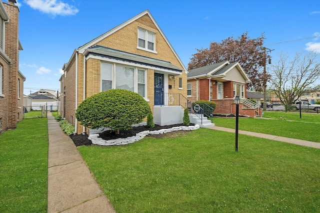 bungalow-style home featuring fence, a front yard, and brick siding