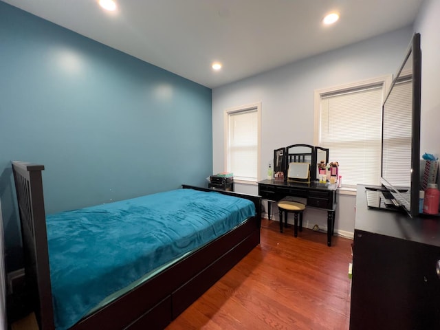 bedroom featuring recessed lighting and wood finished floors