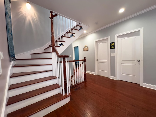 staircase featuring crown molding, recessed lighting, baseboards, and wood finished floors