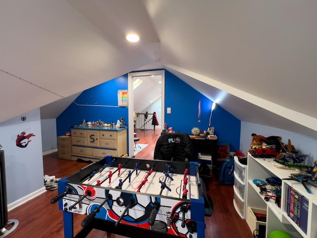 bedroom featuring baseboards, wood finished floors, and vaulted ceiling