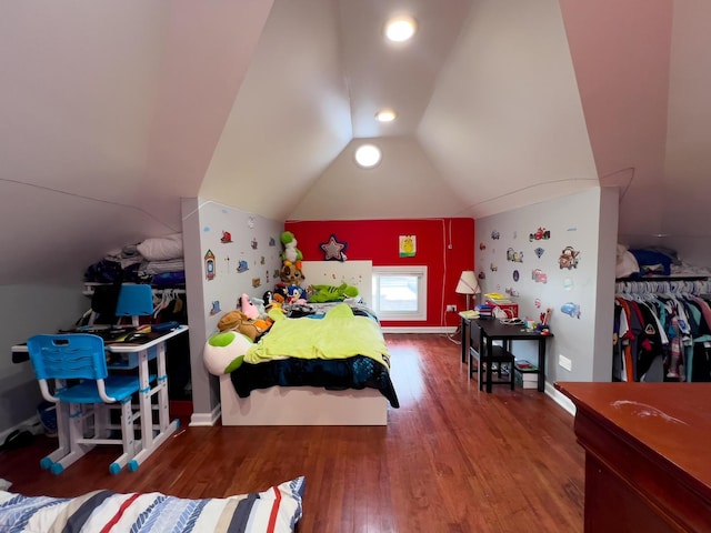 bedroom with vaulted ceiling and wood finished floors