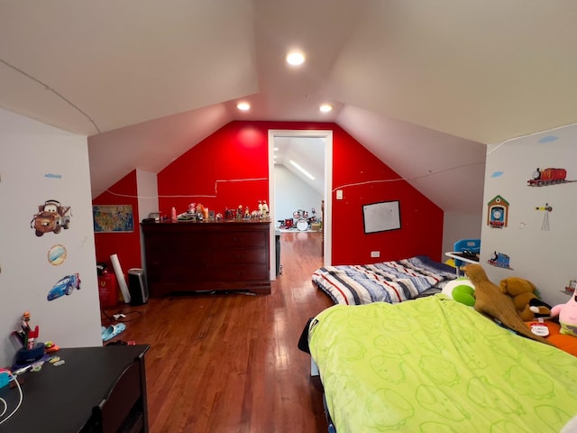 bedroom featuring wood finished floors and vaulted ceiling