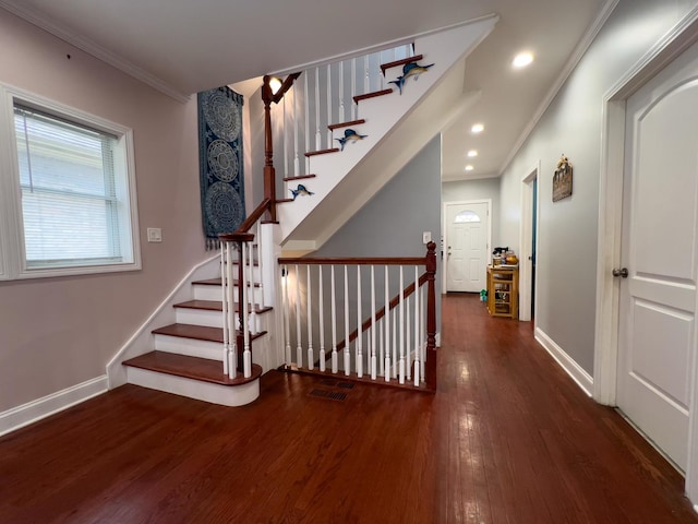 stairway featuring baseboards, ornamental molding, and wood finished floors