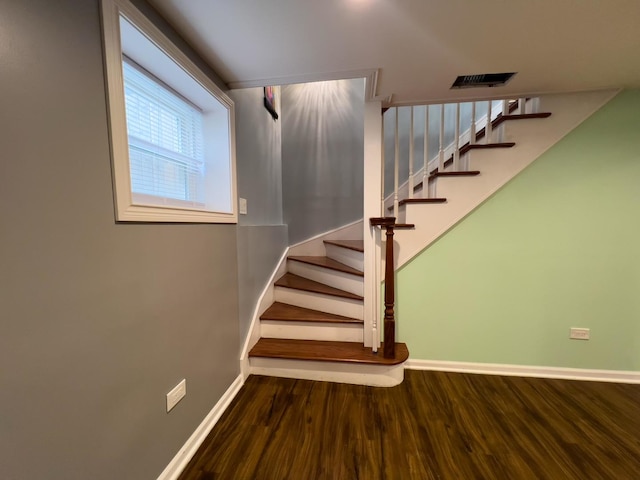 stairway with baseboards and wood finished floors