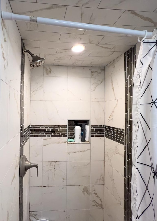 bathroom with a tile shower