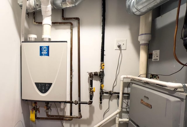 utility room featuring tankless water heater and heating unit