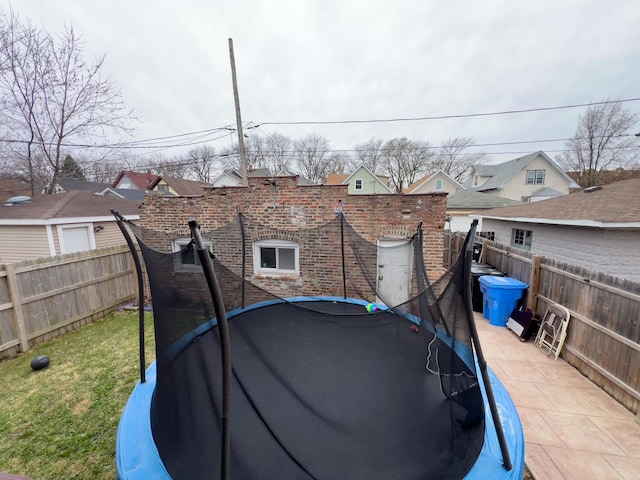 view of yard with a fenced backyard and a trampoline