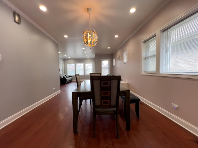 dining space with an inviting chandelier, baseboards, and crown molding