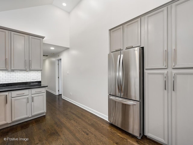 2119 W Evergreen Ave Unit 3W, Chicago, IL 60622 - kitchen featuring freestanding refrigerator, dark countertops, decorative backsplash, baseboards, and dark wood-style flooring