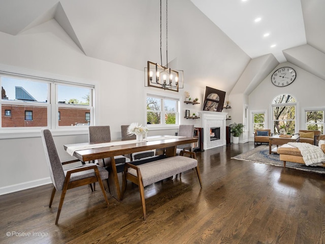 2119 W Evergreen Ave Unit 3W, Chicago, IL 60622 - dining space featuring a lit fireplace, dark wood-style flooring, a chandelier, high vaulted ceiling, and recessed lighting