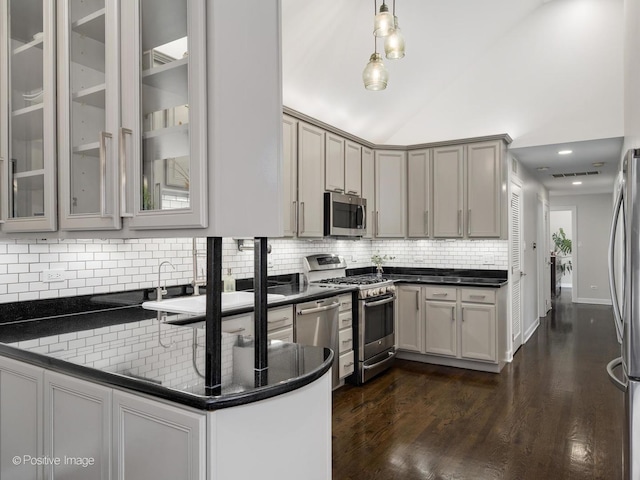 2119 W Evergreen Ave Unit 3W, Chicago, IL 60622 - kitchen with appliances with stainless steel finishes, backsplash, dark wood finished floors, hanging light fixtures, and vaulted ceiling