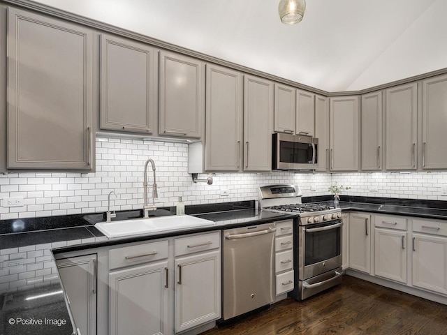 2119 W Evergreen Ave Unit 3W, Chicago, IL 60622 - kitchen with stainless steel appliances, a sink, lofted ceiling, dark countertops, and decorative backsplash