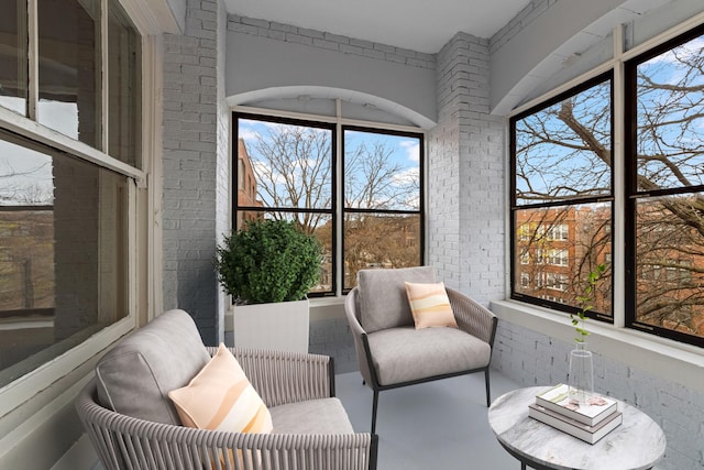 sunroom / solarium featuring radiator heating unit and a healthy amount of sunlight