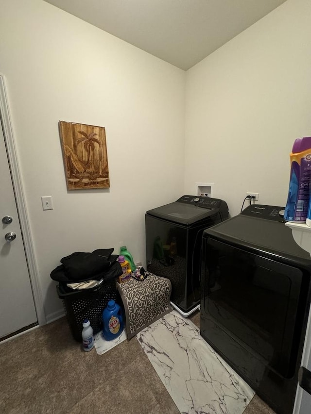 clothes washing area featuring carpet, separate washer and dryer, and laundry area