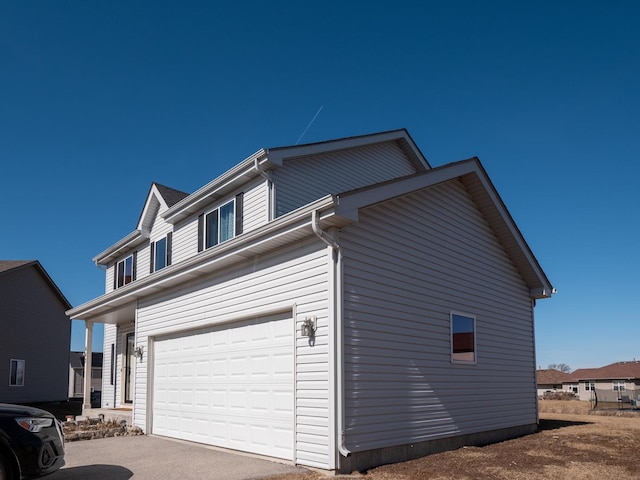 view of property exterior featuring a garage and aphalt driveway
