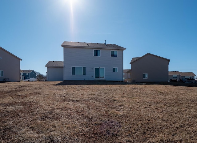 rear view of property with a lawn