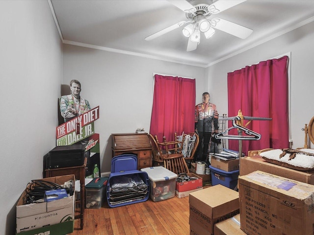 interior space with ornamental molding, ceiling fan, and hardwood / wood-style floors