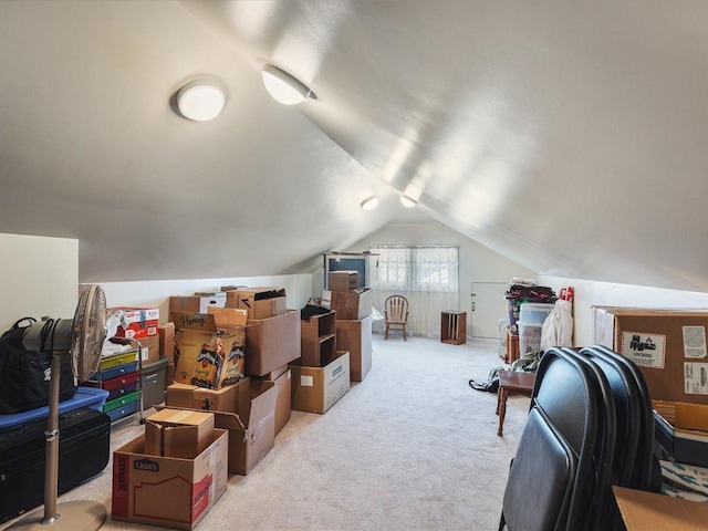additional living space featuring vaulted ceiling and light colored carpet