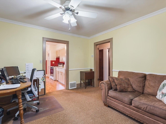 office area with light colored carpet, ornamental molding, ceiling fan, and visible vents