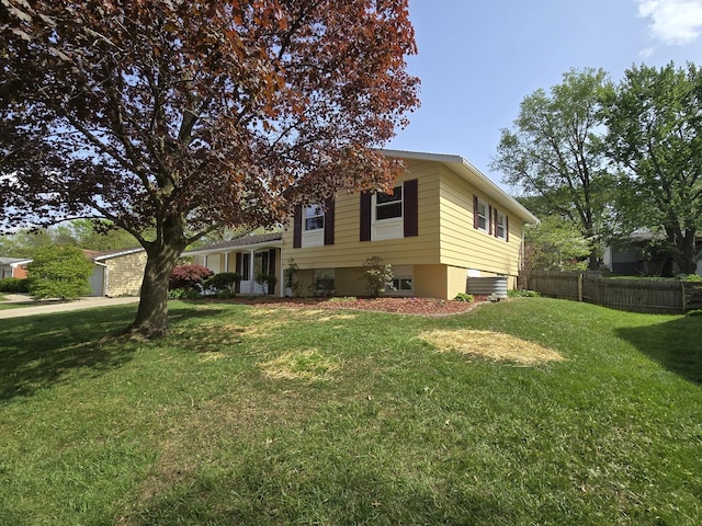 view of front of property with fence and a front lawn