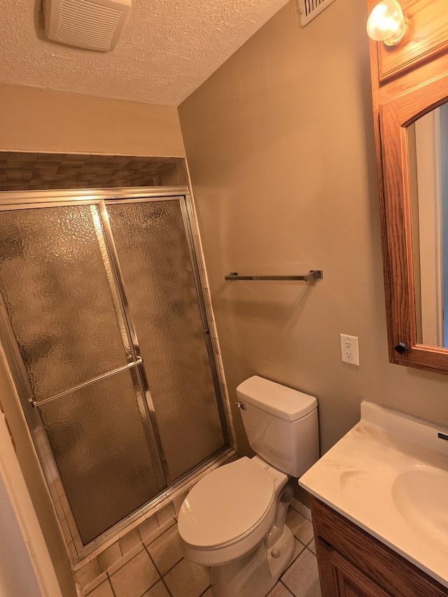 bathroom featuring a textured ceiling, tile patterned floors, visible vents, and a stall shower