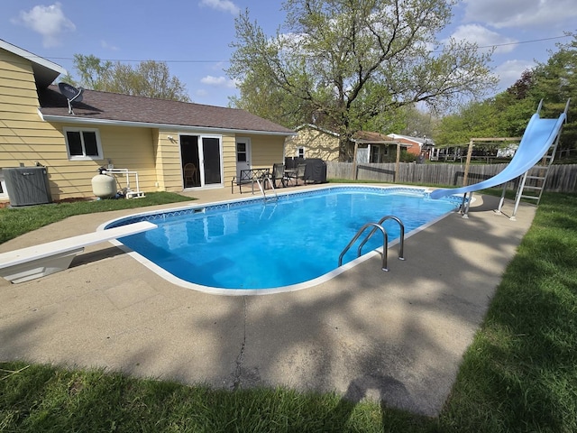 view of pool with a fenced backyard, a fenced in pool, a water slide, and a patio area