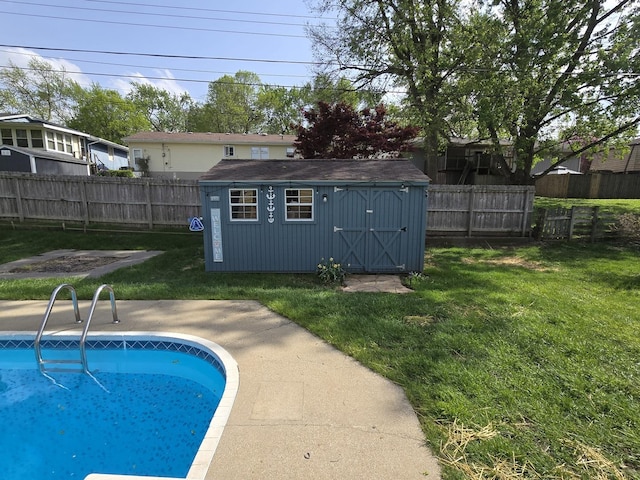 view of pool with a storage shed, a lawn, and a fenced backyard